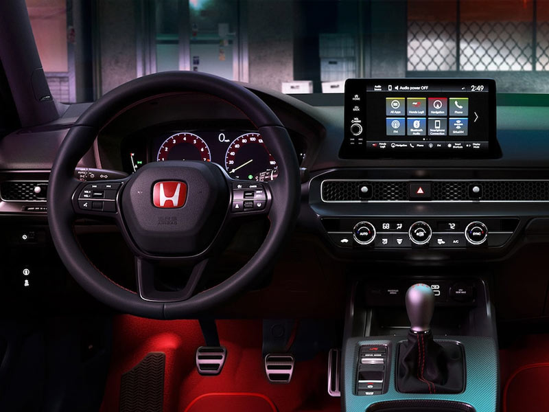 Honda vehicle interior with advanced infotainment system, digital dashboard, and driver-focused controls, highlighting modern technology, connectivity, and comfort features.