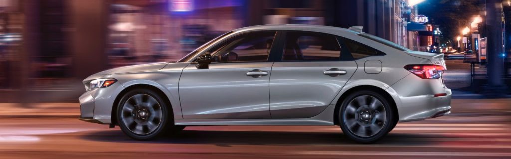 2026 Honda Civic riding in the city at mid-night with its advance technology and feature.
